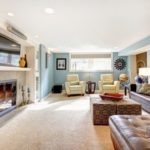 Comfortable family room with sectional, recliners, and carpeting.